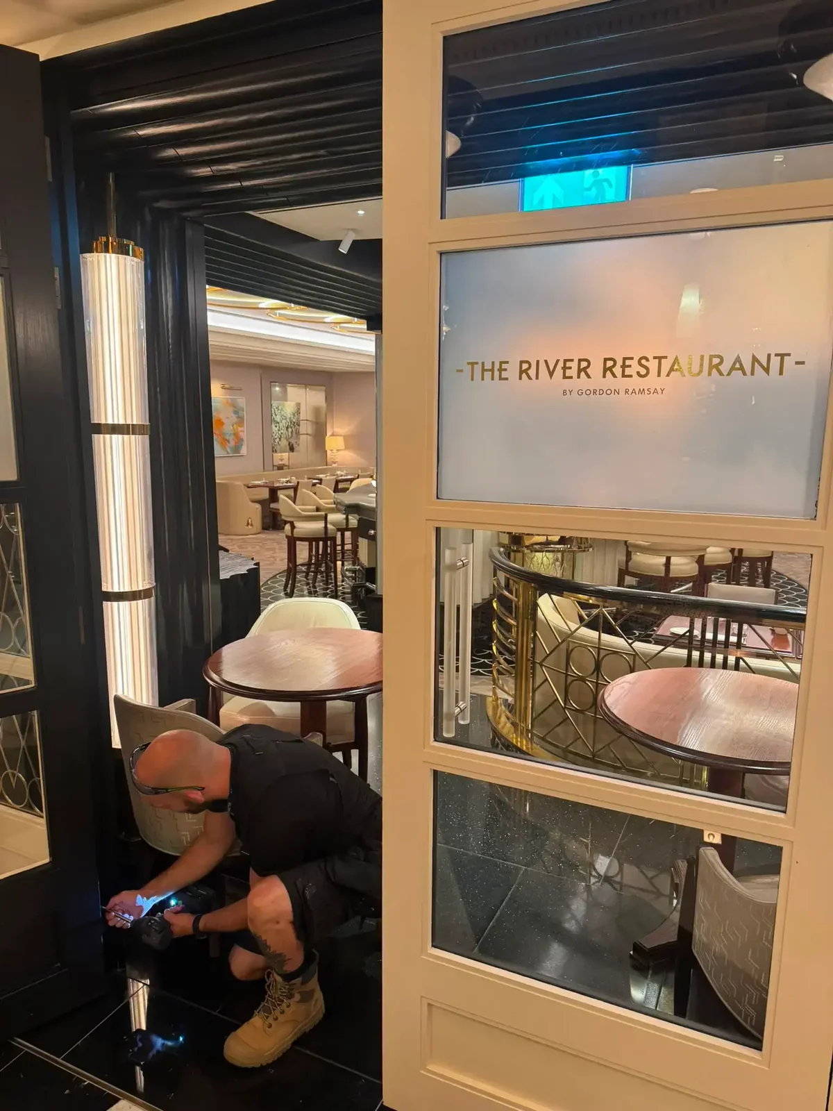 Sentinel Projects director fitting fire door hardware at The River Restaurant by Gordon Ramsay, London