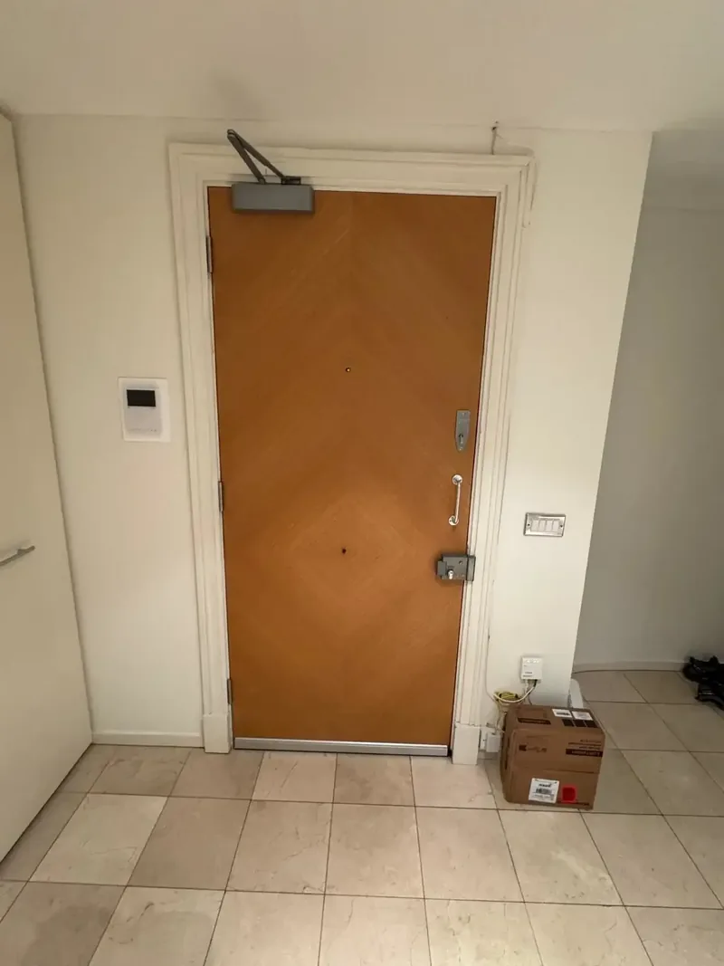 Completed fire door installation with overhead self-closer
