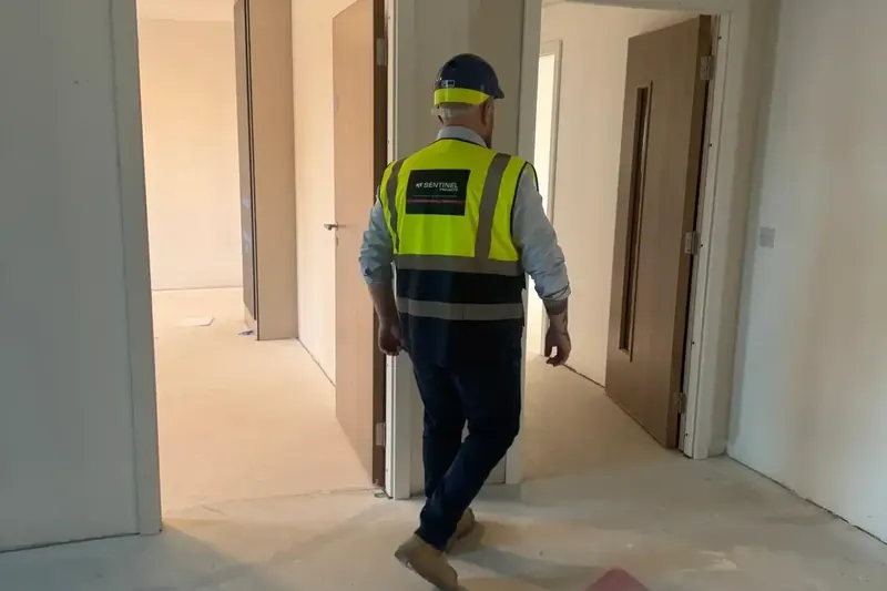 Sentinel Projects director walking through a residential flat surveying new fire doors